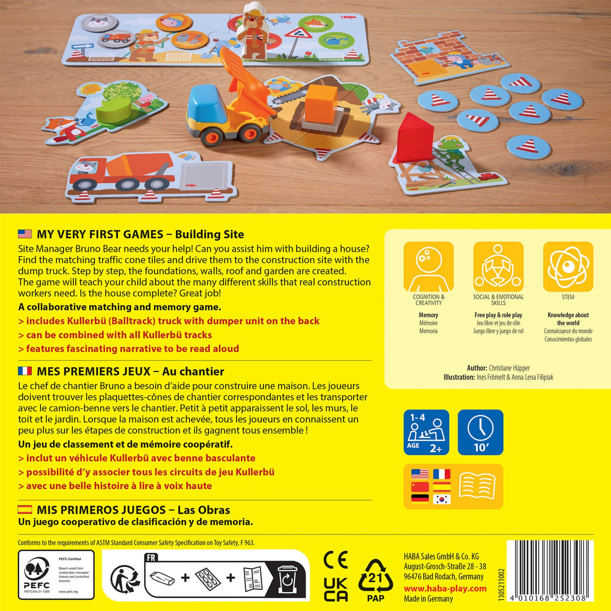 Children's educational game set on a wooden surface with game pieces and instructions.