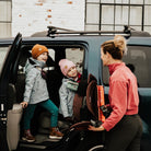 Woman with two children getting into a car