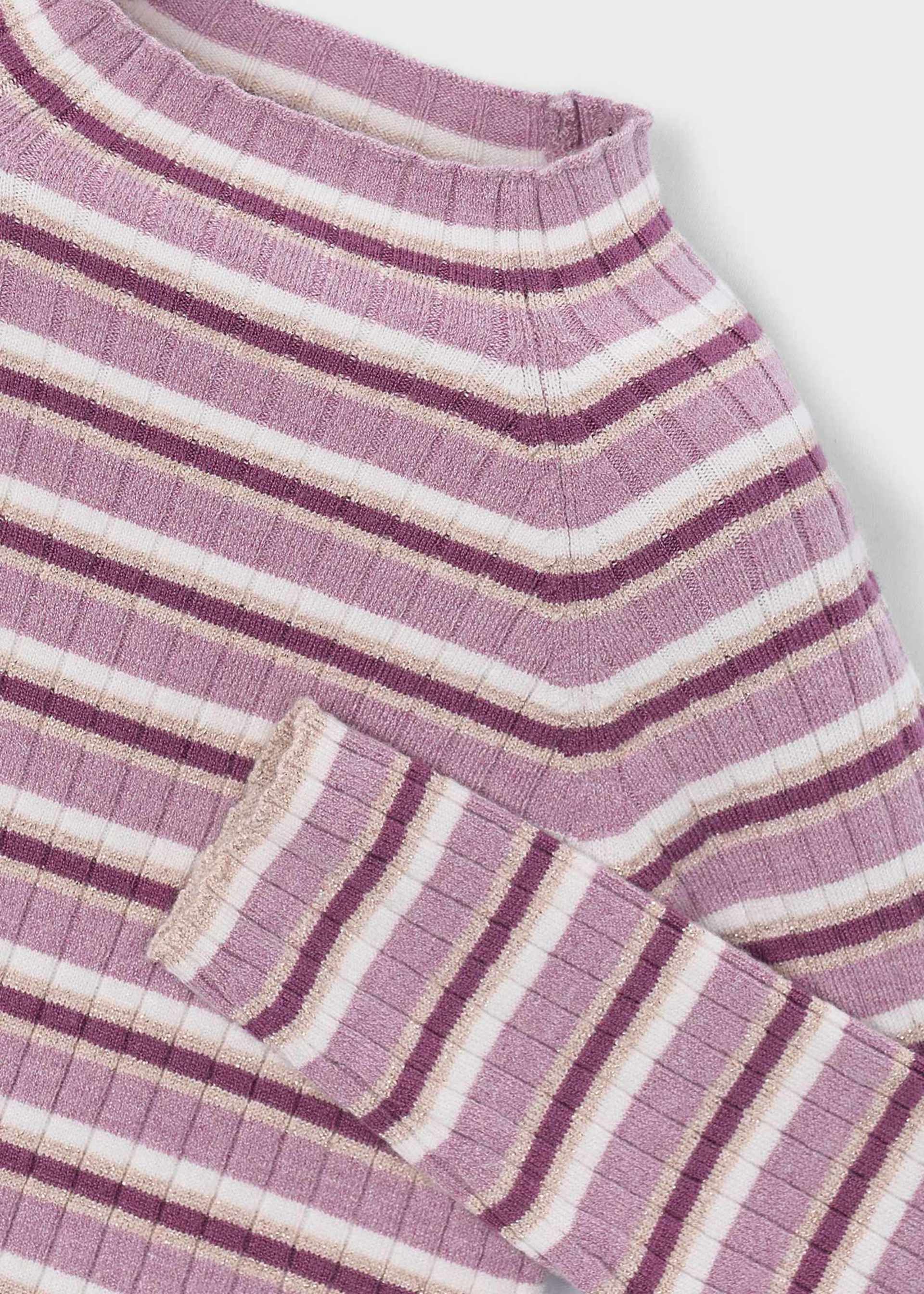 Close-up of a purple and white striped fabric with a pocket detail on a light gray background