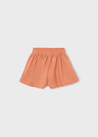Orange shorts on a light gray background