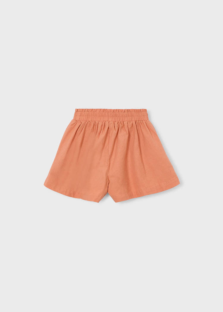 Orange shorts on a light gray background