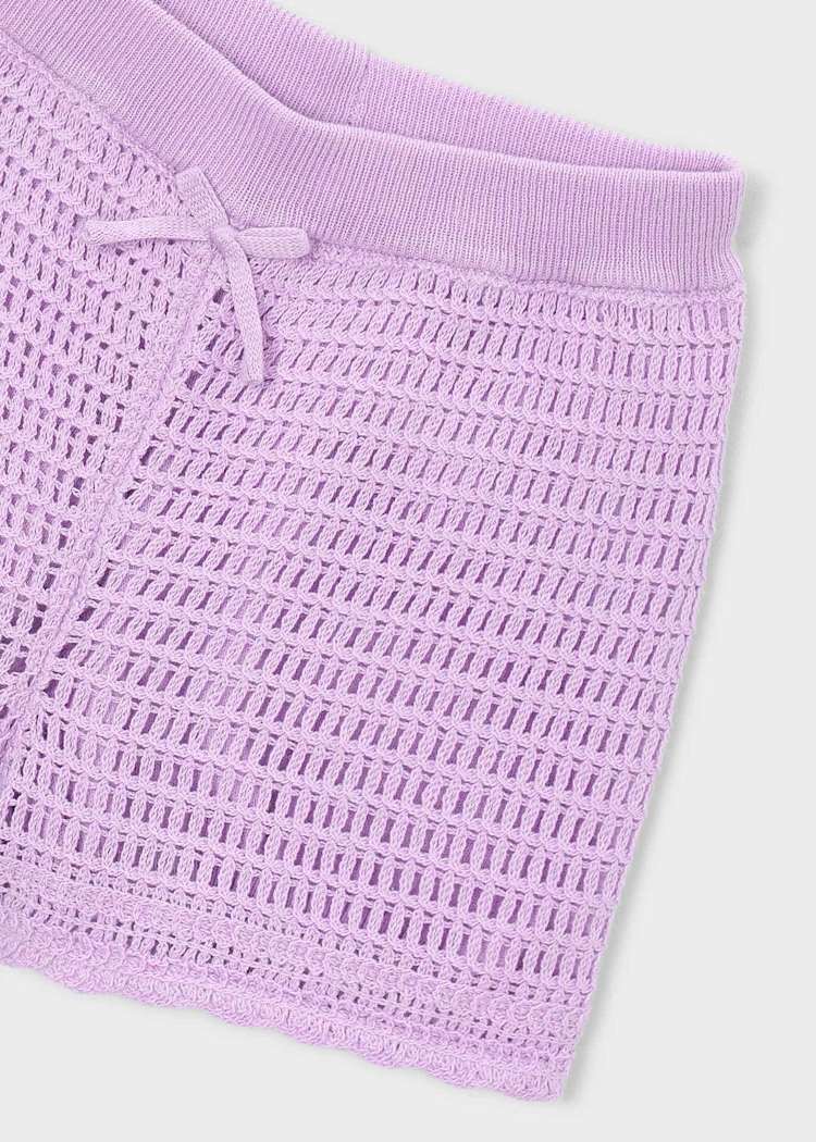 Close-up of a textured purple fabric with a white background