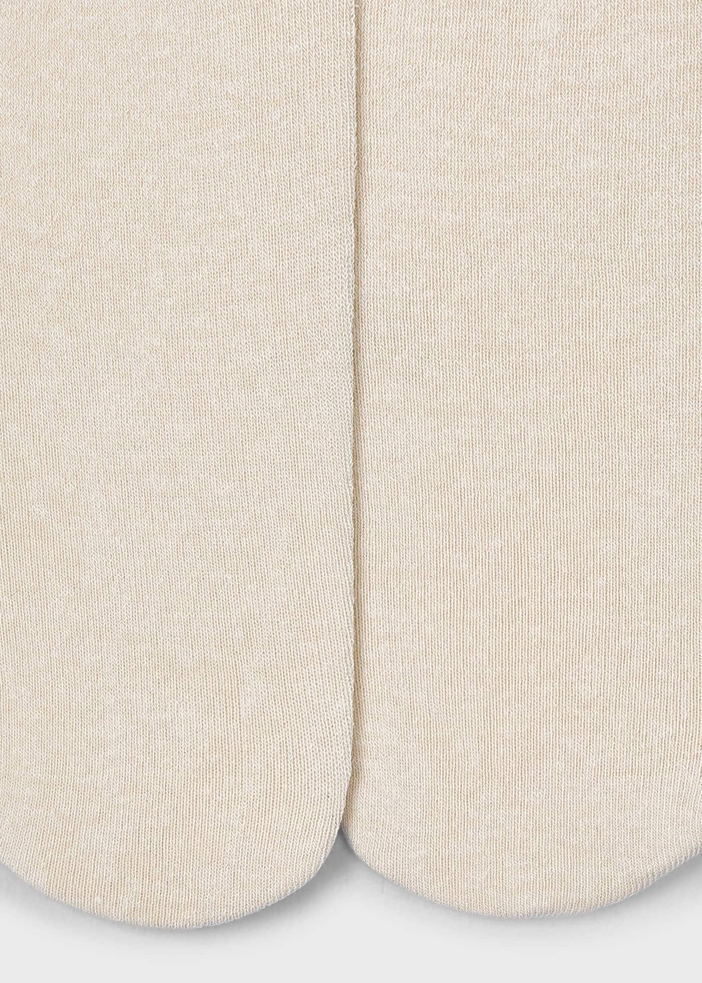 Close-up of beige socks on a light gray background