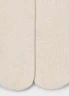 Close-up of beige socks on a light gray background