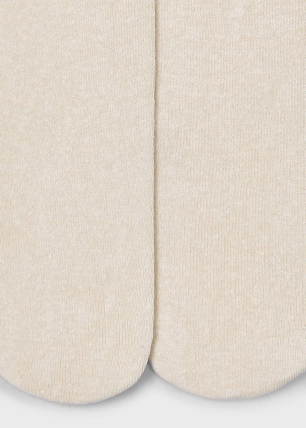 Close-up of beige socks on a light gray background