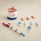 Fishing toy set with a bucket, rod, and accessories on a white background