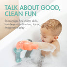 A baby in a bubble bath holding an orange toy bottle attached to a teal bath strap, with marketing text reading 'TALK ABOUT GOOD, CLEAN FUN' on a white tub background.