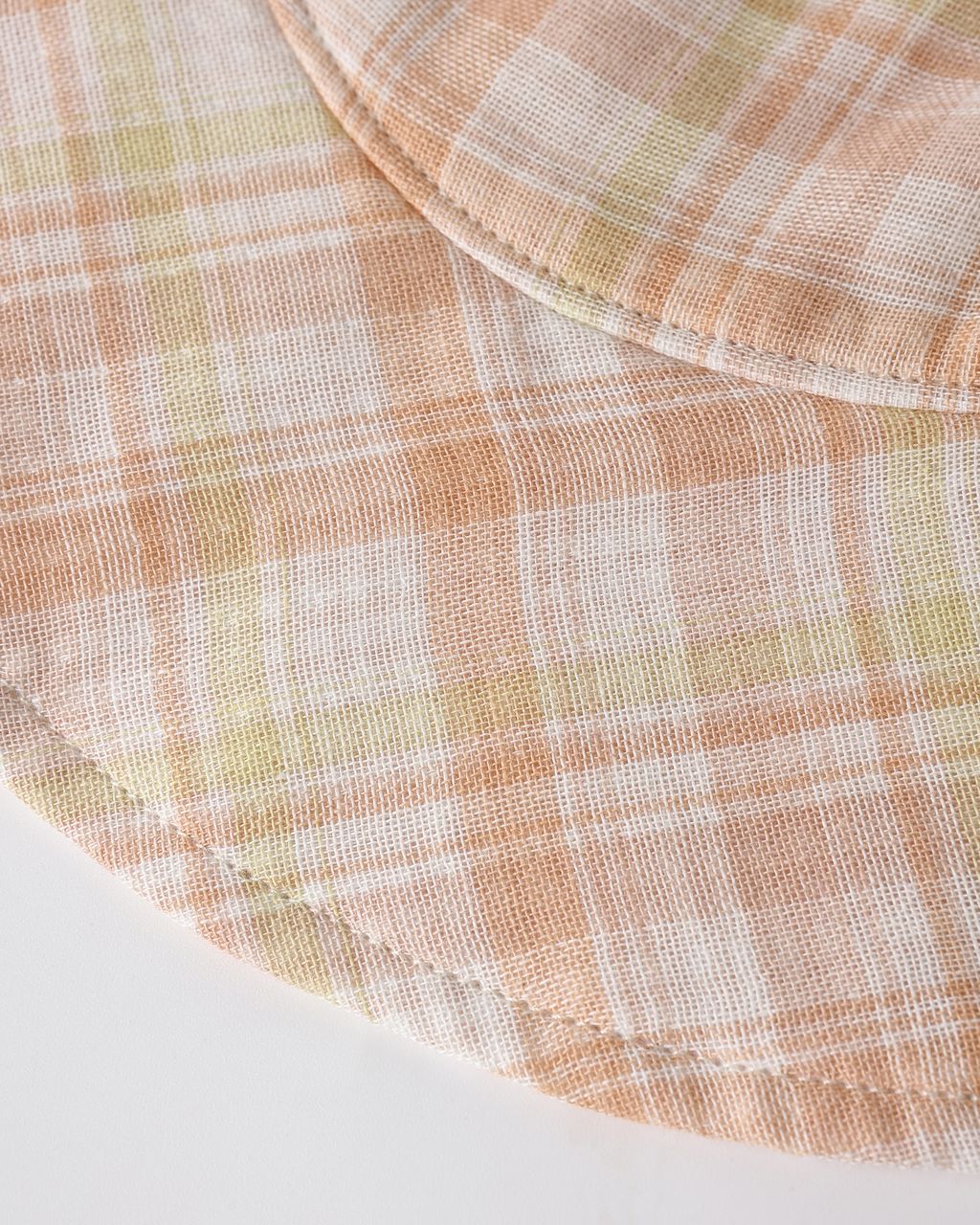 Close-up of a checkered fabric with pastel colors on a white background