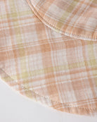 Close-up of a checkered fabric with pastel colors on a white background