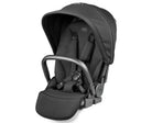 A Peg Perego infant car seat in a black fabric with a black handle and black harness straps, shown on a clean white background.