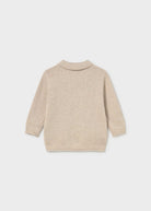 A light beige knit sweater shown from the back, featuring a mock neck and ribbed cuffs and hem, photographed against a neutral light gray background.