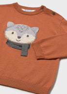 Brown sweater with a wolf face design on a white background