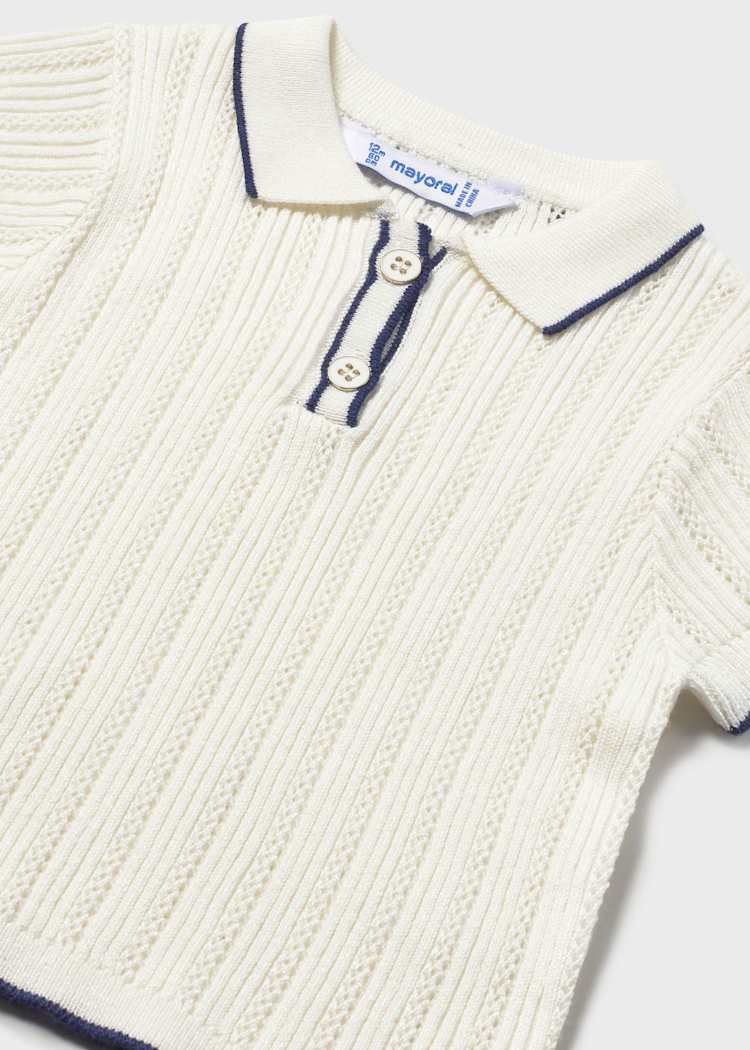 Close-up of a ribbed knit sweater with button details on a white background