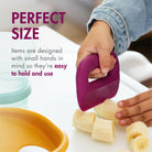 Child's hand holding a purple tool over sliced bananas with text about item size suitability.