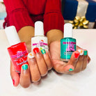 Three bottles of Piggie Paint nail polish held by a person with colorful nails.