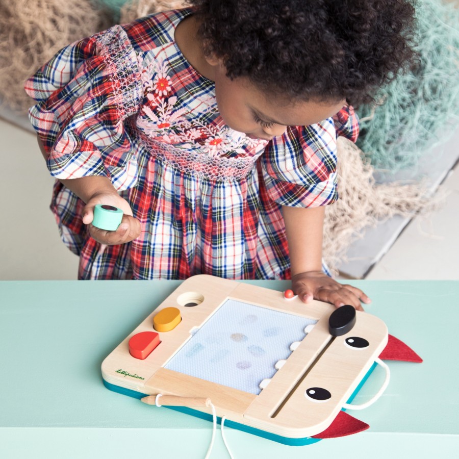 Child playing with a wooden toy on a light blue surface
