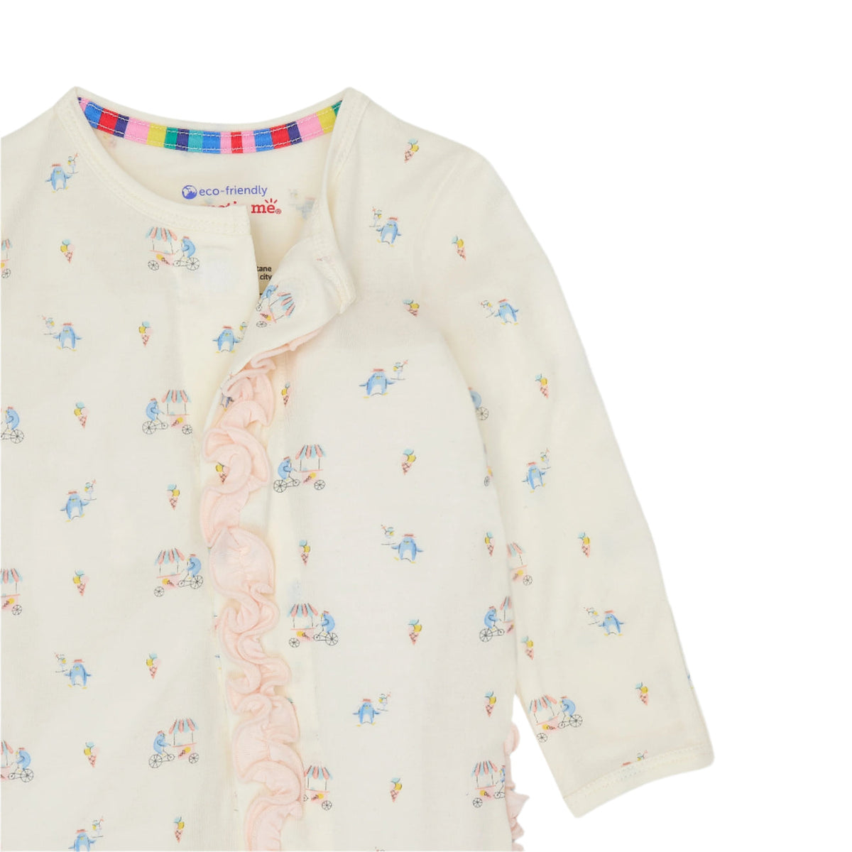 A close-up of a baby long-sleeve top in cream, featuring a delicate print of blue birds and pink buggies, with a light pink ruffle trim down the front and a colorful striped inner collar.