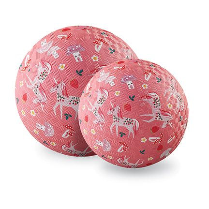 Two pink exercise balls with unicorn patterns on a white background
