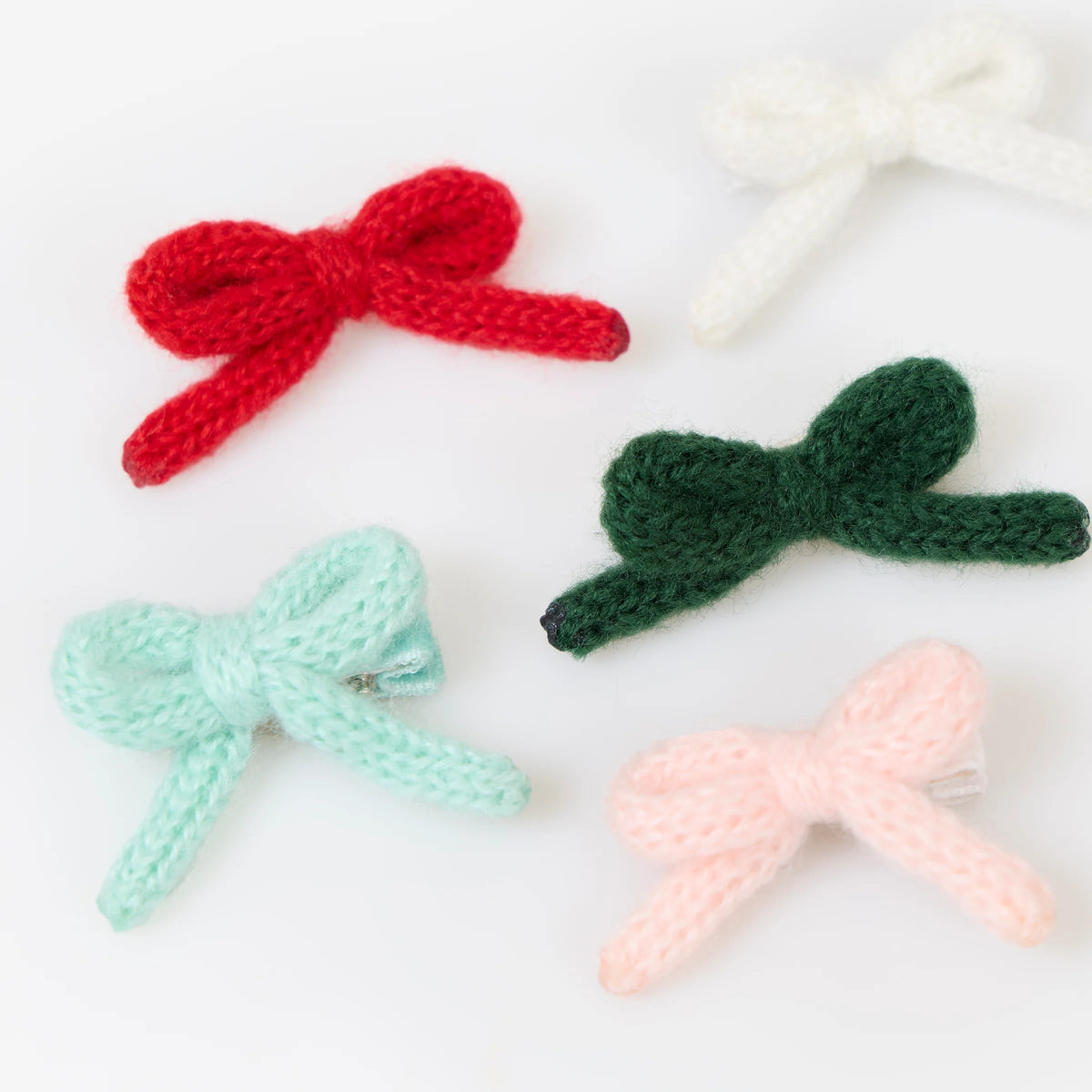 Charming bow hairclips in a colorful assortment of red, green, light blue, pink, and white.