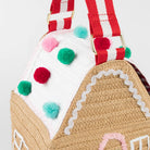 Gingerbread house-shaped bag with pom-pom details on a white background