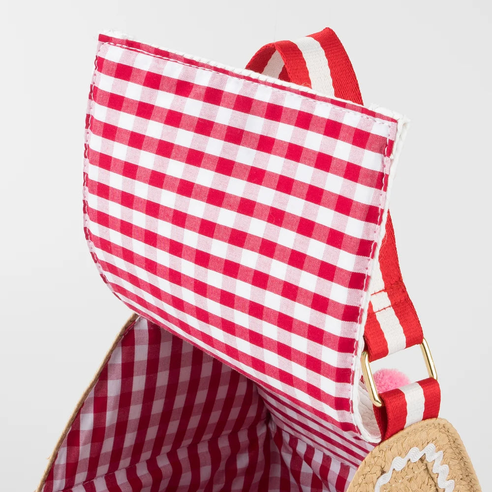 Red and white checkered bag with a straw handle on a light gray background