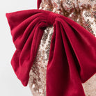 Close-up of a red bow on a sequined fabric background