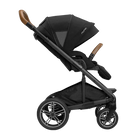 A profile view of a black MIXX Next + Pipa Aire RX Travel System by Nuna stroller featuring brown leatherette handlebar and armbar accents, shown against a checkered transparent background.