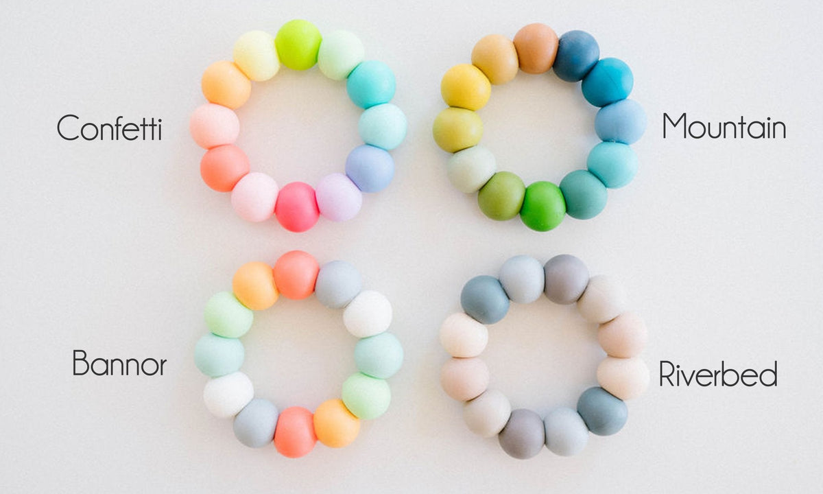 Four colorful beaded bracelets labeled 'Confetti', 'Mountain', 'Banner', and 'Riverbed' on a white background.