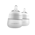 Two white nanobébé baby bottles with clear silicone nipples, shown on a clean white background.