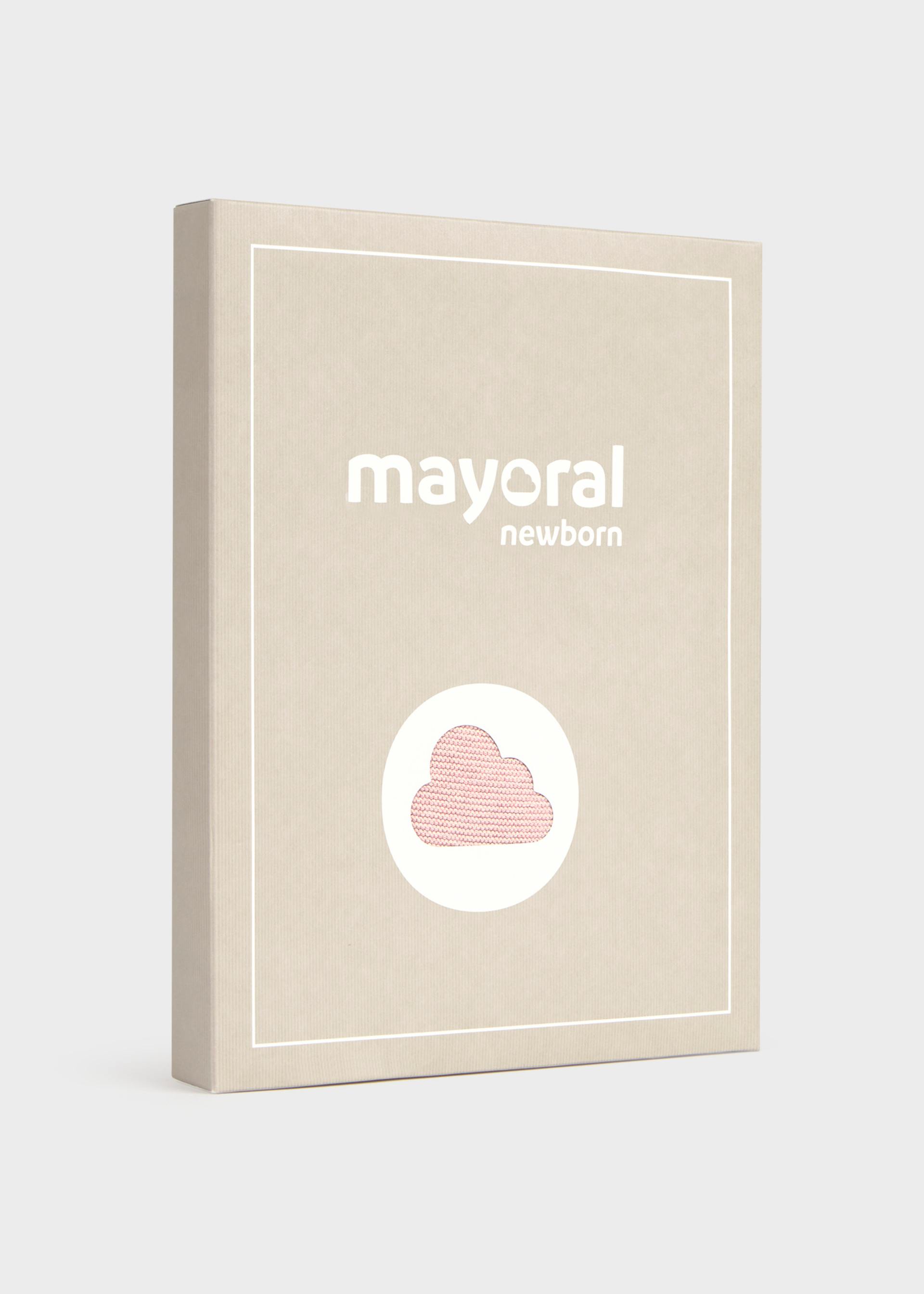 A rectangular beige product box or package standing upright on a light gray background. The front has white border lines, the text 'mayoral newborn' in white, and a white oval containing a pink cloud illustration.
