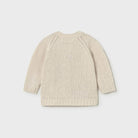 Beige knitted sweater on a light gray background