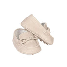 Pair of beige baby shoes on a white background