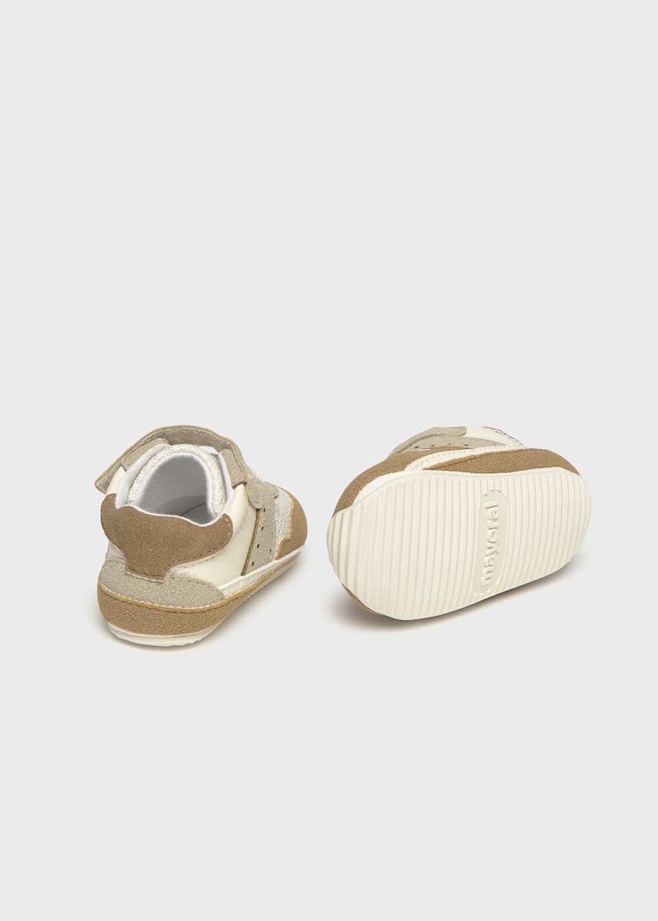 Pair of baby shoes on a light gray background