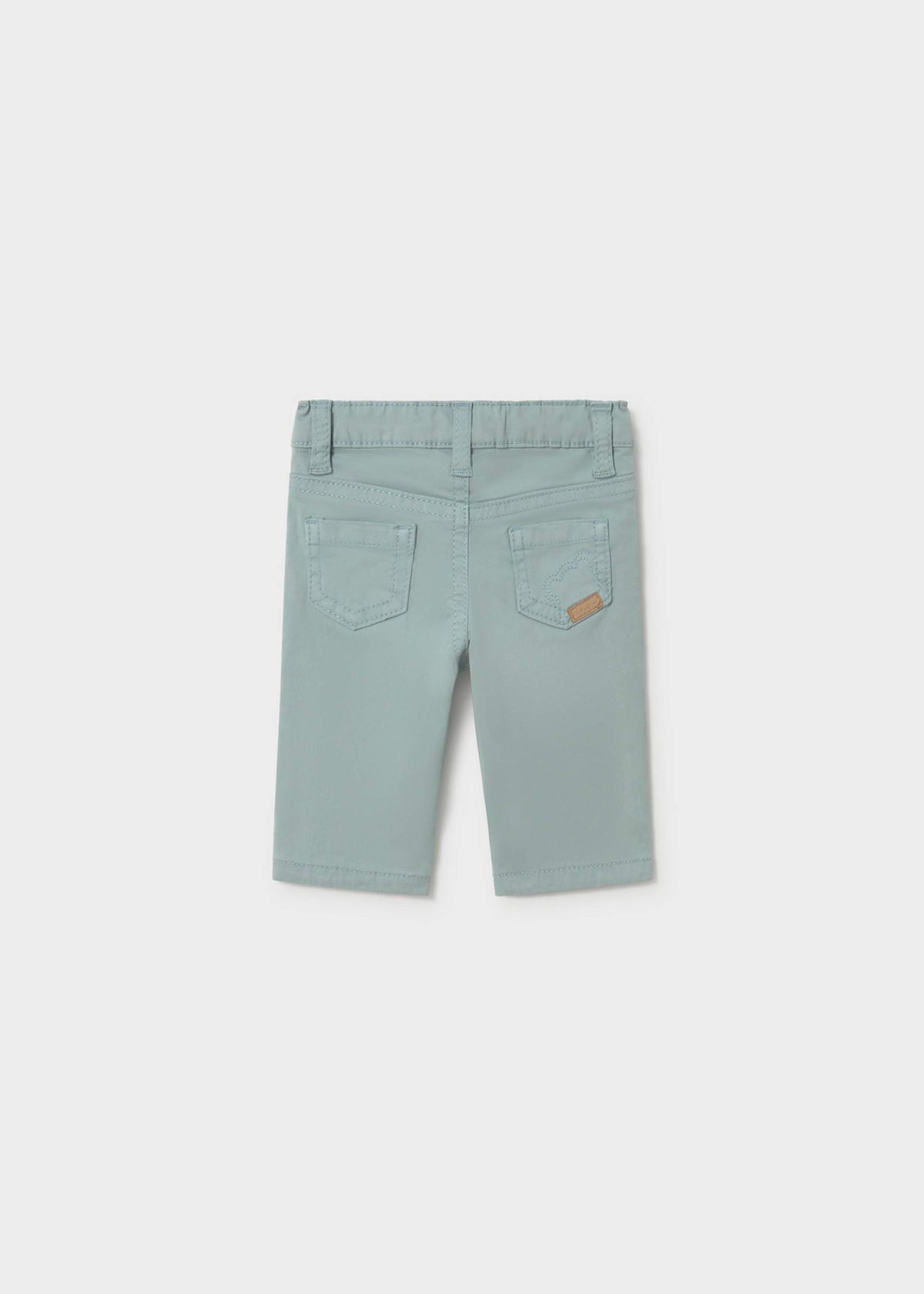 A pair of light sage green denim shorts for kids, shown from the back on a neutral light gray background.