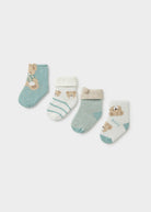 Set of four baby socks with bear designs on a light gray background