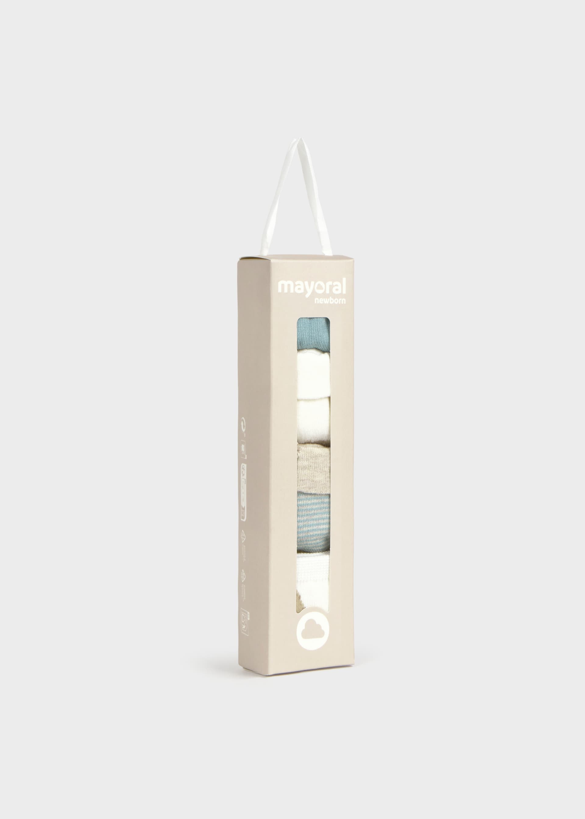 A tall, narrow beige cardboard package with a transparent window displaying folded socks in white, light blue, and gray. The brand name 'mayoral' is printed near the top, and a white hanging loop is attached at the top of the box.