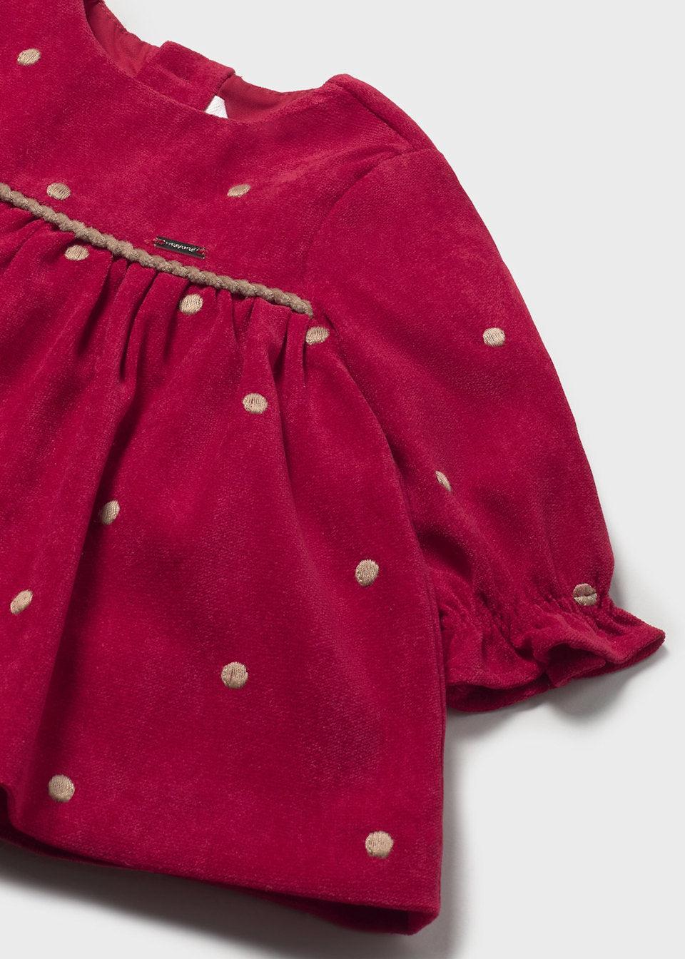 Red dress with gold polka dots on a white background