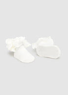White floral earrings on a light gray background