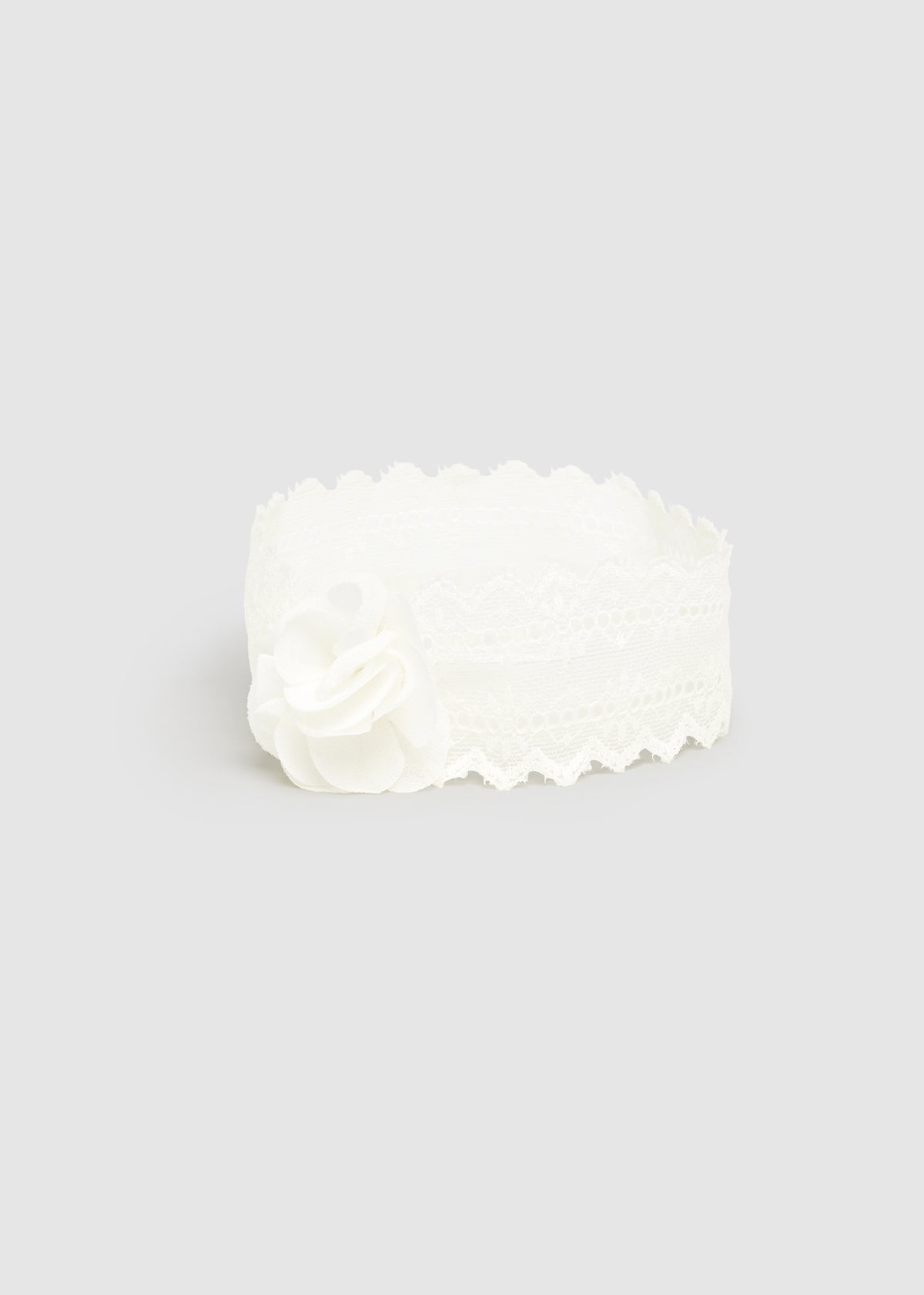 White lace headband on a light gray background
