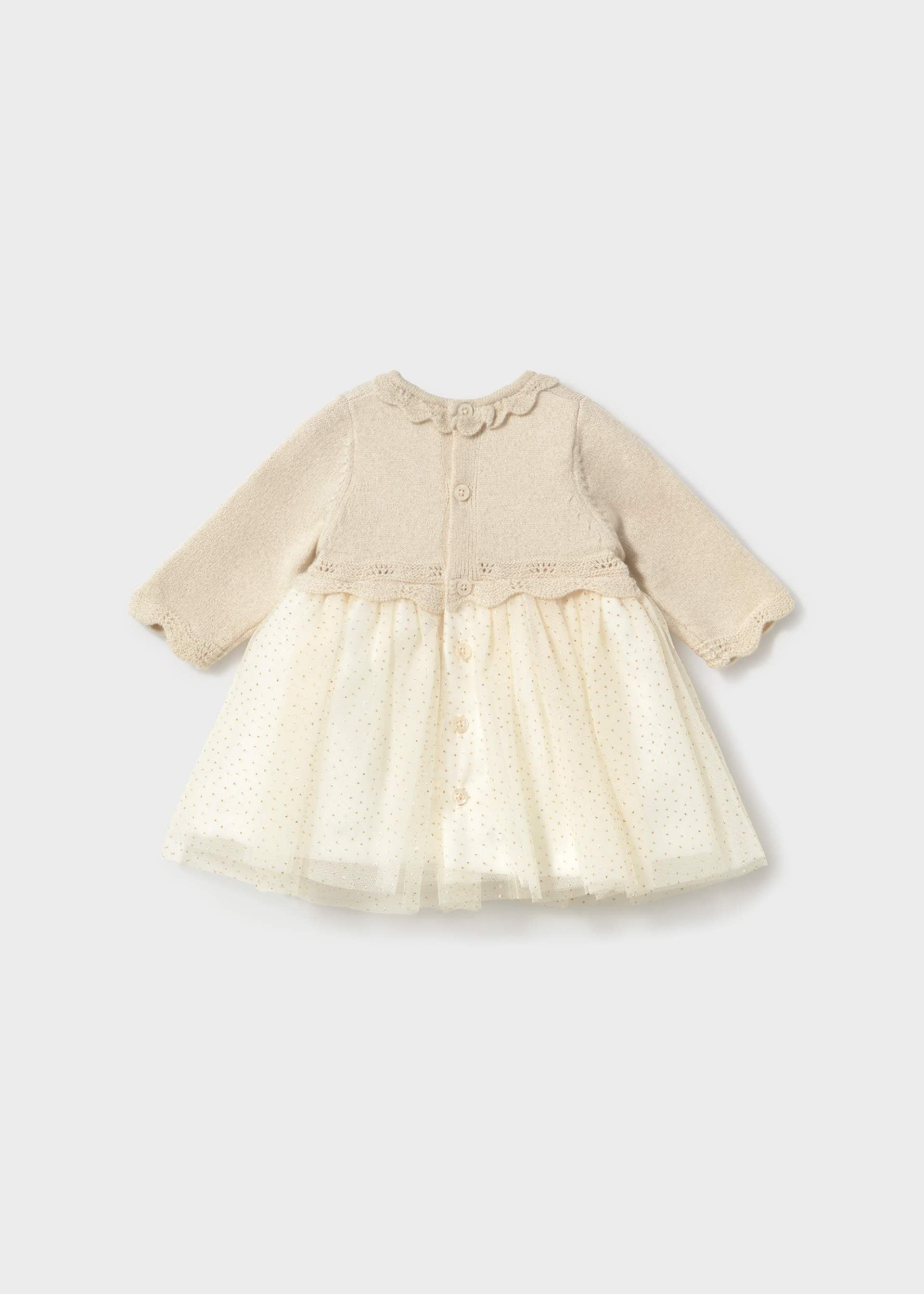 A baby girl's long-sleeve dress with a beige knit bodice and a cream tulle skirt, shown against a light gray background.
