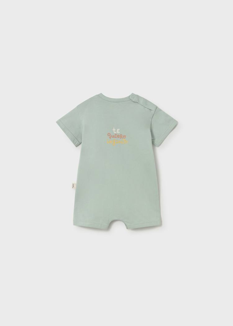 Light green baby romper with text on a white background