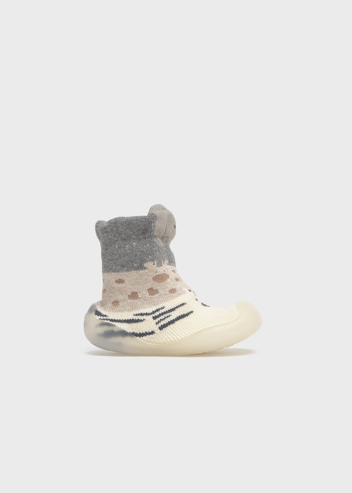 Baby shoe with gray top and white sole on a light gray background