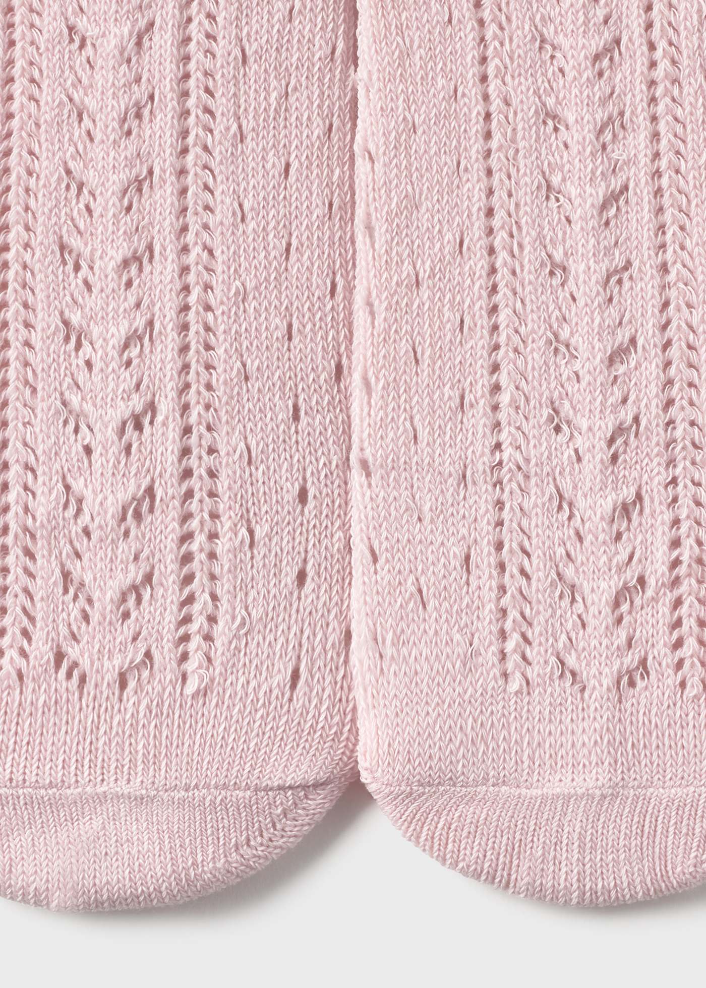 Close-up of pink knitted baby booties with a textured pattern on a white background