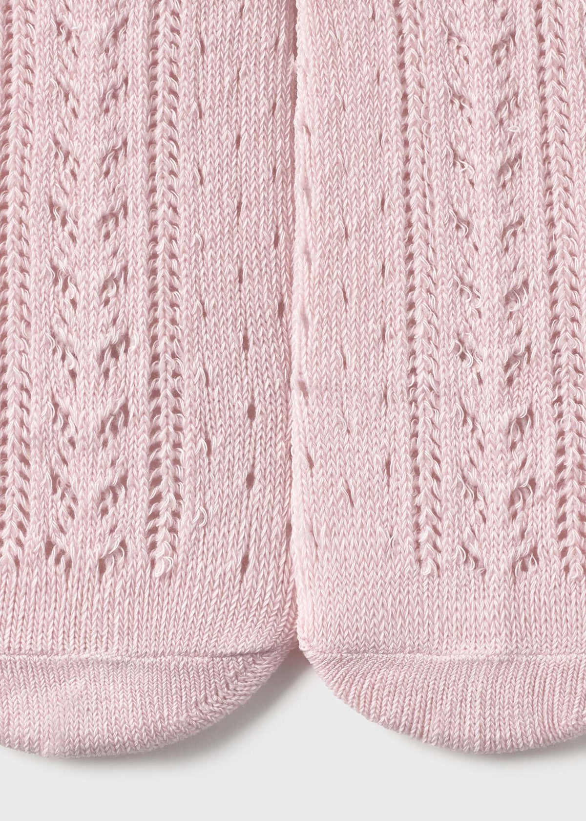 Close-up of pink knitted baby booties with a textured pattern on a white background
