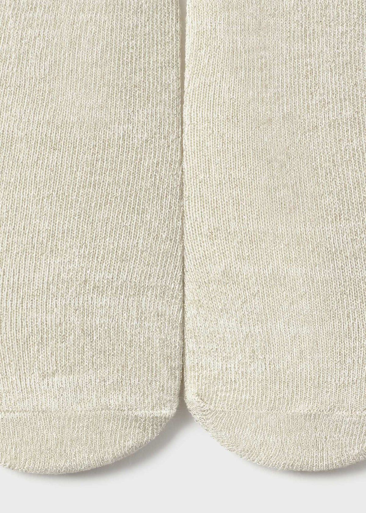 Close-up of beige socks on a light gray background