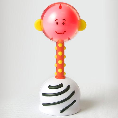 Toy rattle with a smiling face on a white background