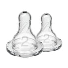 Two clear baby bottle nipples with '2' marking on a white background