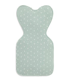 Light green baby mat with white moon pattern on a white background