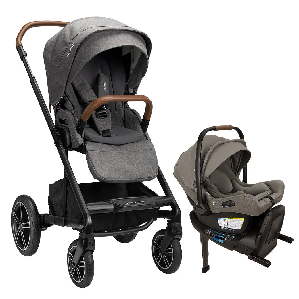 A profile view of a MIXX Next + Pipa Aire RX Travel System by Nuna stroller and infant car seat in Granite, shown against a clean white background. The stroller features a black frame, gray fabric upholstery, and a brown leatherette handlebar and armbar, while the matching infant car seat is positioned to the right on its base.