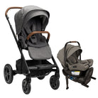A profile view of a MIXX Next + Pipa Aire RX Travel System by Nuna stroller and infant car seat in Granite, shown against a clean white background. The stroller features a black frame, gray fabric upholstery, and a brown leatherette handlebar and armbar, while the matching infant car seat is positioned to the right on its base.